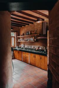 a kitchen with wooden cabinets and a counter top at Glamping en Casa Viento in Tepoztlán