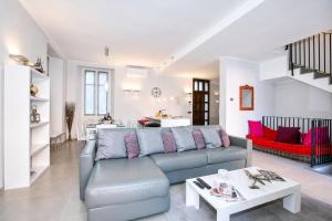 a living room with a couch and a table at Villa Lucia Laglio in Laglio +37 photos