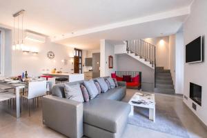 a living room with a couch and a dining room at Villa Lucia Laglio in Laglio