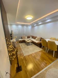 a living room with a couch and a table at AJ Apartments in Kosovo Polje