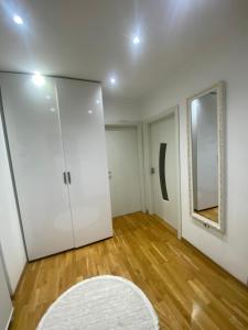 an empty room with a door and a mirror at AJ Apartments in Kosovo Polje