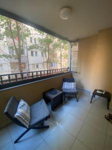 a room with two chairs and a window at AJ Apartments in Kosovo Polje