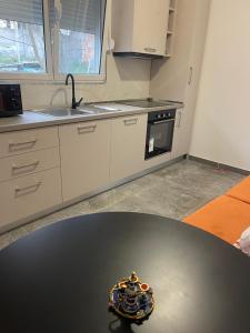 a kitchen with a table with a bowl on top of it at Durres Garden Stay in Durrës +3 photos