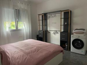 a bedroom with a bed and a washing machine at Durres Garden Stay in Durrës