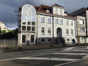 a white building on the side of a street at ApartZ - Celle - CityQuartier - bis 15 Personen - 4 Apartments in Celle