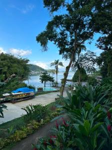 a view of a body of water with a boat at Hotel Ibiza in Angra dos Reis