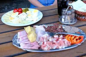 two plates of food on a wooden table at Gasthaus Kopper in Guttaring