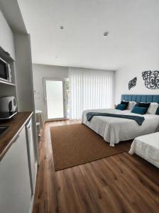 a bedroom with a large bed and a television at Hotel de Charme Casa Fundevila in Vila Verde