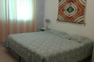 En eller flere senger på et rom på Appartamenti in Cadaques Caribe