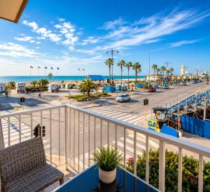 a balcony with a view of the beach and the ocean at Hotel La Pace in Viareggio