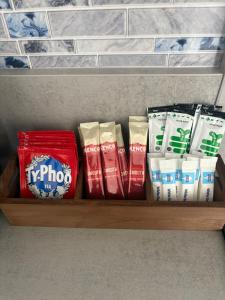 a shelf with different types of toilet paper on it at Pork pie pad in Melton Mowbray +1 photo