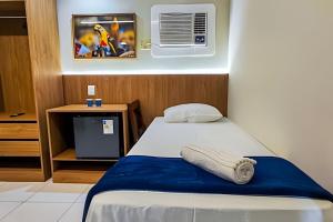 a bedroom with a bed and a air conditioner at Refúgio da Praça: Charme e Conforto in Belém +110 photos