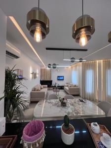 a living room with a couch and a table at Résidences kenza in Kelibia