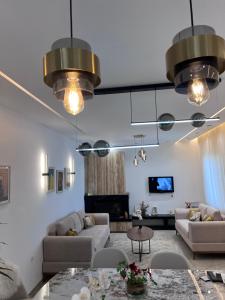 a living room with two couches and a fireplace at Résidences kenza in Kelibia +2 photos