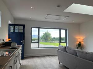 a living room with a couch and a large window at Little Hills in Westport