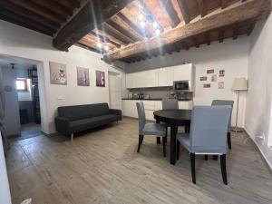 a living room with a table and chairs and a couch at LA CASETTA di AURORA in Riomagno