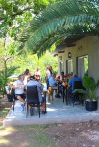 a group of people sitting at tables on a patio at La Elegida Villars in General Las Heras