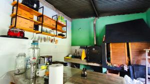 a kitchen with green walls and a wooden counter top at La Elegida Villars in General Las Heras +9 photos