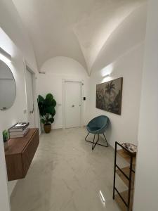 a living room with a table and a chair at La dimora del duomo boutique suites & rooms in Terrasini +65 photos