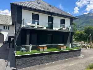 a house with a glass balcony on the side of it at T2 modern in Frontenex-Villard-Rosset