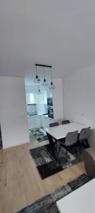 a dining room with a table and chairs at Apartman Eldin Panonika in Tuzla
