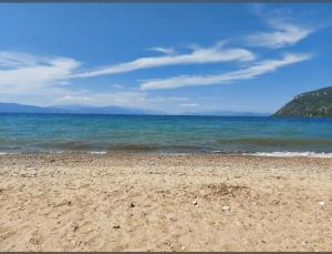 a sandy beach with the ocean in the background at The blue lagoon in Ohrid +5 photos