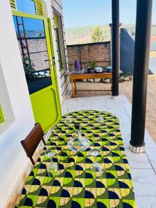 a table with glasses on it on a patio at Blue Home Stay in Janjagiro