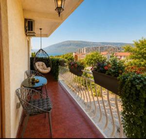 a balcony with a table and chairs and a view at Seaside Apartments - Vasilije in Baošići +1 photo