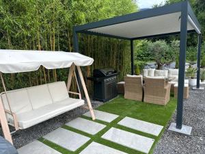 a gazebo with two chairs and a grill at T2 modern in Frontenex-Villard-Rosset +2 photos