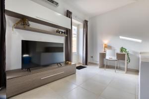 a living room with a large flat screen tv at NEW - 2BR Beach side apt by SF HOMES in Sliema