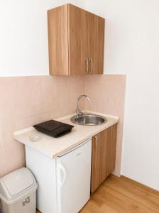a small kitchen with a sink and a toilet at M Apartments 2 in Bar