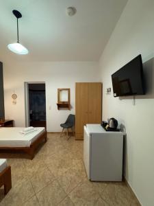 a room with a bed and a tv on a wall at Dream catcher 1 in Agia Theodoti