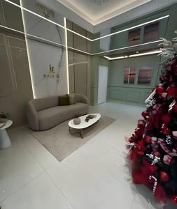 a living room with a couch and a christmas tree at Itapema in Itapema +39 photos