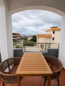 a wooden table and chairs on a balcony at M Apartments 2 in Bar +6 photos