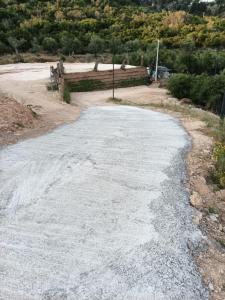 an empty road with gravel on the side at Escape Suites in Dhërmi
