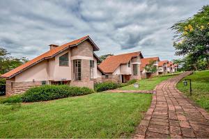 a row of houses on a brick road at Sagana Getaway Resort in Maranjua