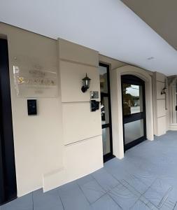a white wall in a building with glass doors at Itapema in Itapema