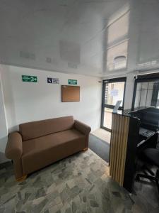 a living room with a couch and a desk at Hospedaje ZIG ZAG 2 in Tocancipá