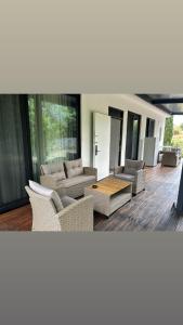 a living room with couches and a table at Escape Suites in Dhërmi