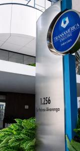 a sign in front of a building with plants at TFL EXECUTiVE PREMIUM FARIA LIMA - ITAIM in São Paulo