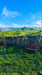 a bench on top of a hill with a view at Shahdag Berghoff Villas in Qusar