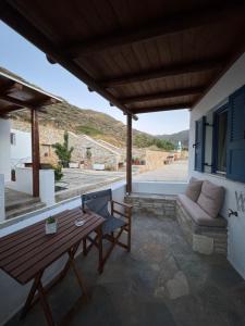 a patio with a wooden table and a couch at Dream catcher 1 in Agia Theodoti