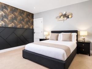 a bedroom with a large bed and two lamps at The Hillcrest, Luxury Accommodation in Castleblayney Town in Castleblayney