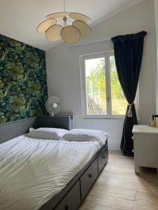 a bedroom with a large bed and a window at Pavilion de LaFue in Lavergne +38 photos