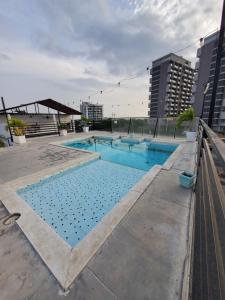 a swimming pool on the roof of a building at Hostel HM Caribe in Santa Marta