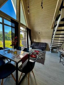 a dining room with a table and chairs at Шале WeLKoMe in Verkhovyna