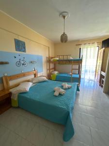 a bedroom with a bed with two towels on it at LEFKADIOS HERN studios in Lefkada