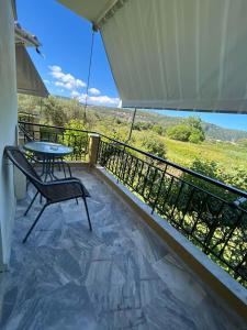 a balcony with a table and chairs and a view at LEFKADIOS HERN studios in Lefkada