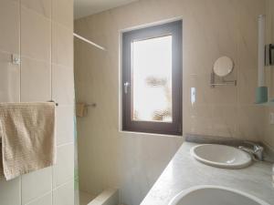 a white bathroom with a sink and a window at Casa Zapato in La Pared +65 photos