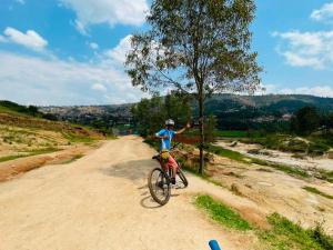 a person on a bike on a dirt road at Blue Home Stay in Janjagiro